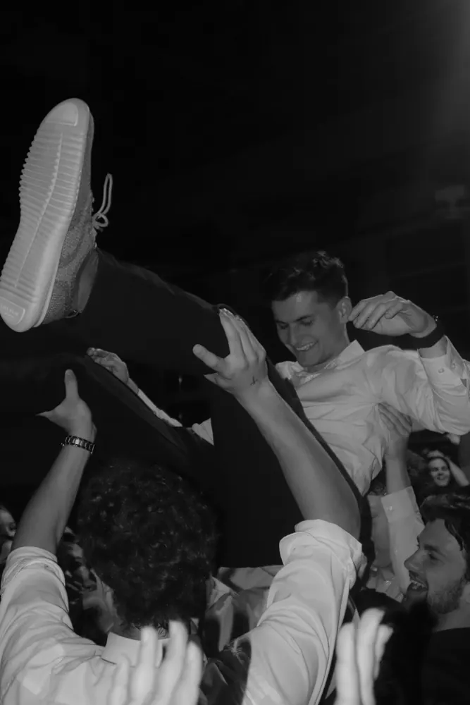 Crowd surfing at a live show, black and white
