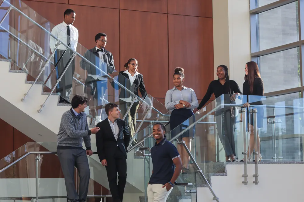 Corporate team portrait on a glass staircase