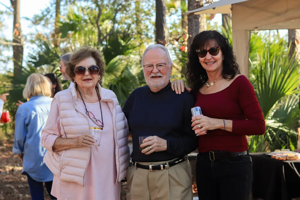Guests posing at an outdoor evening event